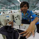 A worker sews a garter to a skirt in a garment factory outside Phnom Penh, Cambodia. Photo by World Bank, Flickr. Licensed under CC BY-NC-ND 2.0.